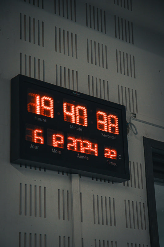 A digital clock mounted to the side of a building