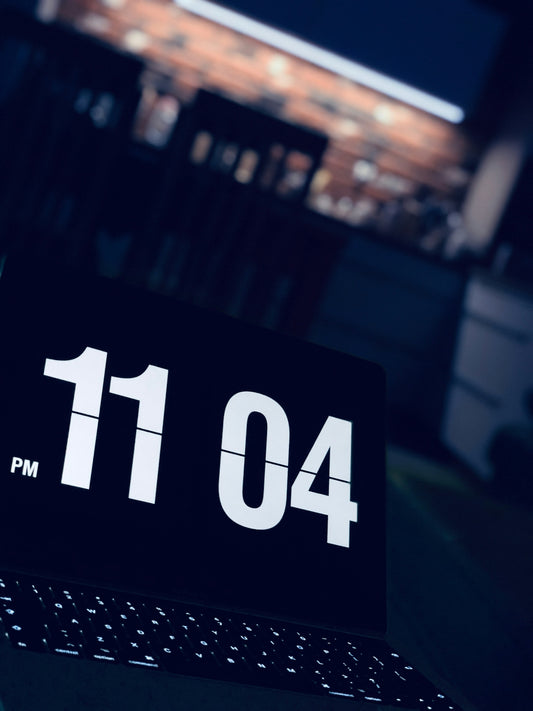 a close up of a black and white clock on a laptop