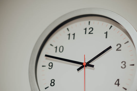 round silver analog wall clock displaying 1:48 time