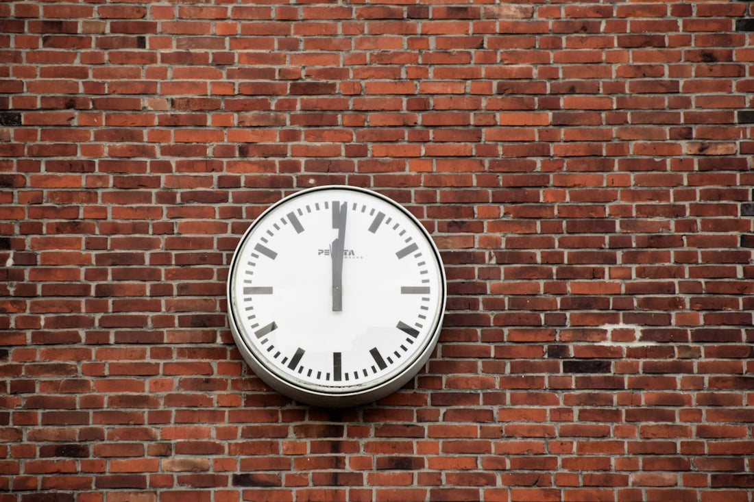 round white and black analog clock at 12;00