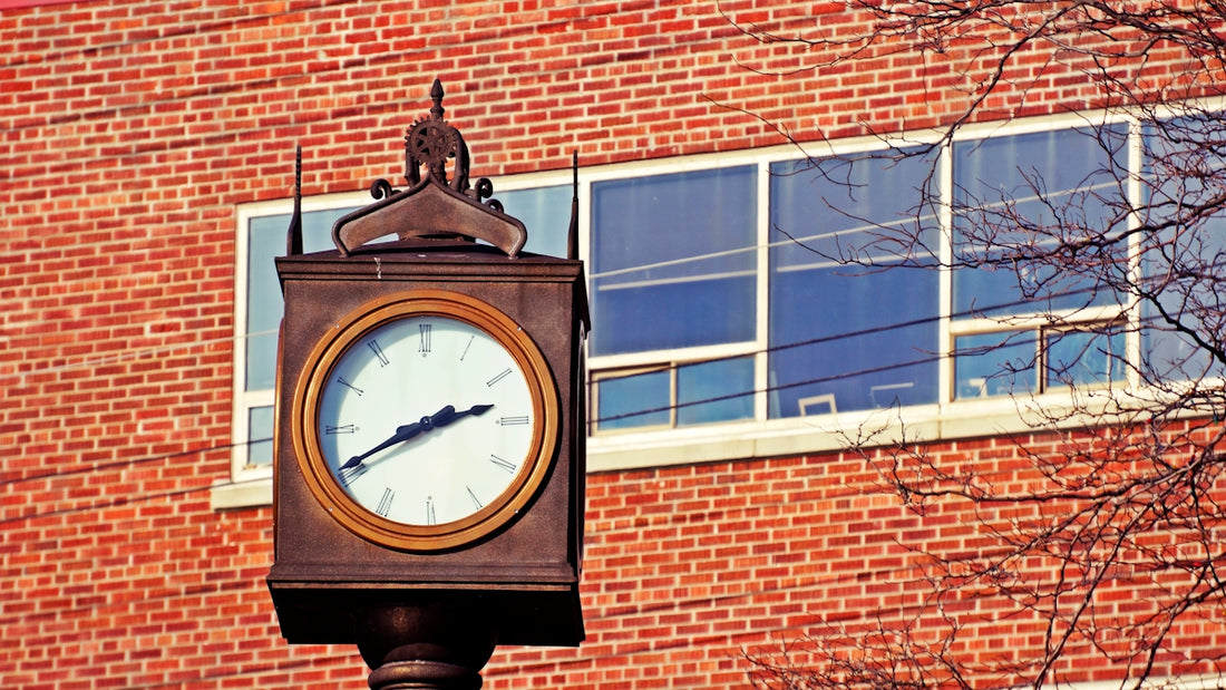 brown wooden framed analog wall clock at 10 00