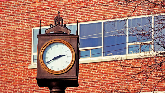 brown wooden framed analog wall clock at 10 00