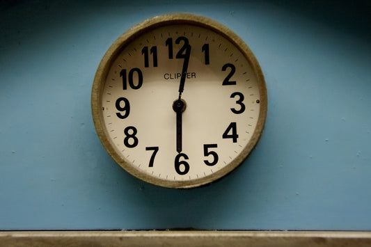 white and brown analog wall clock at 10 00