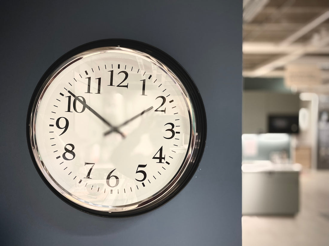 a clock is hanging on the wall of a building