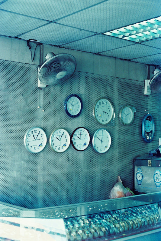a bunch of clocks that are on the wall
