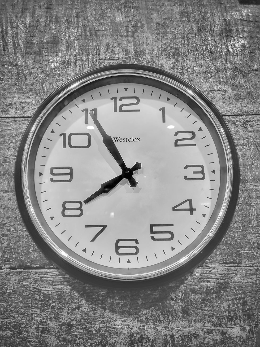 a black and white photo of a clock