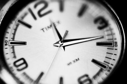 a black and white photo of a clock