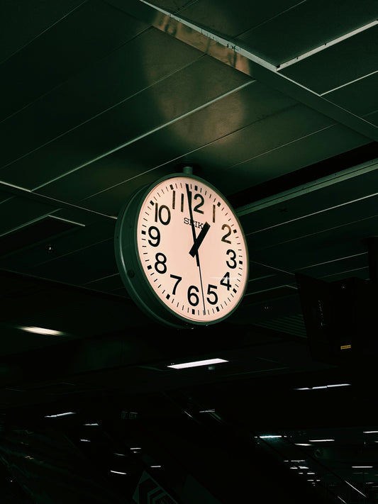 a large clock hanging from the ceiling of a building