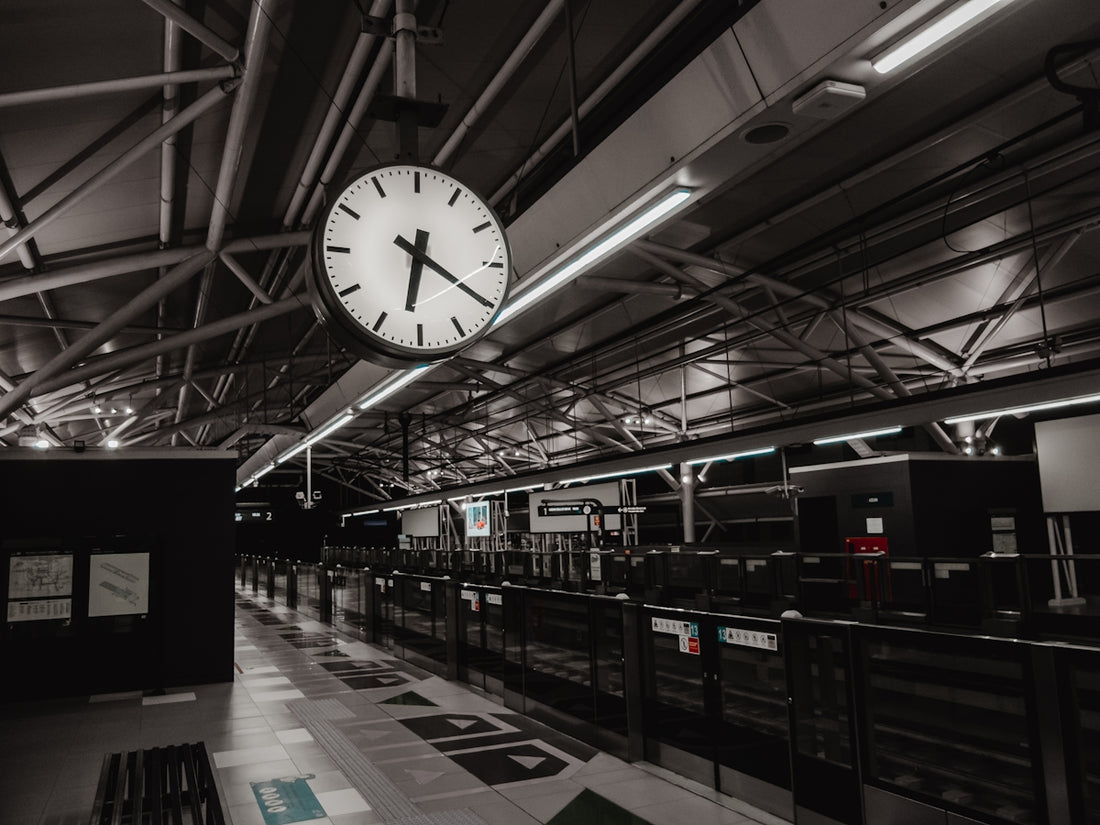 a large clock hanging from the ceiling of a building