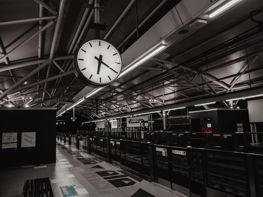 a large clock hanging from the ceiling of a building