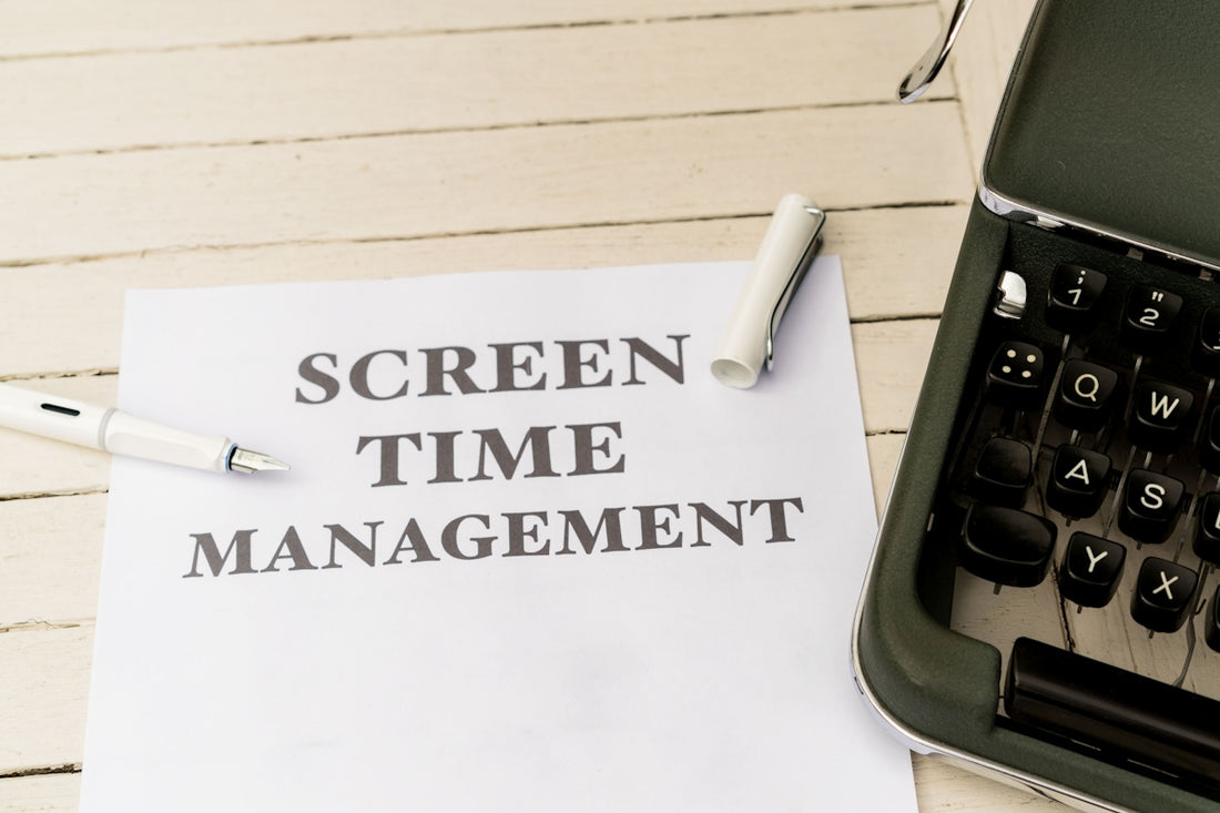 a piece of paper that says screen time management next to a typewriter
