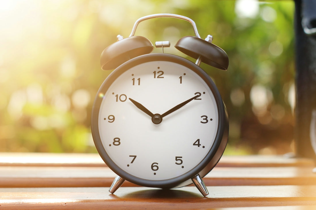 an alarm clock sitting on top of a wooden table