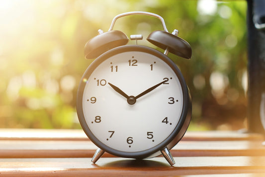 an alarm clock sitting on top of a wooden table