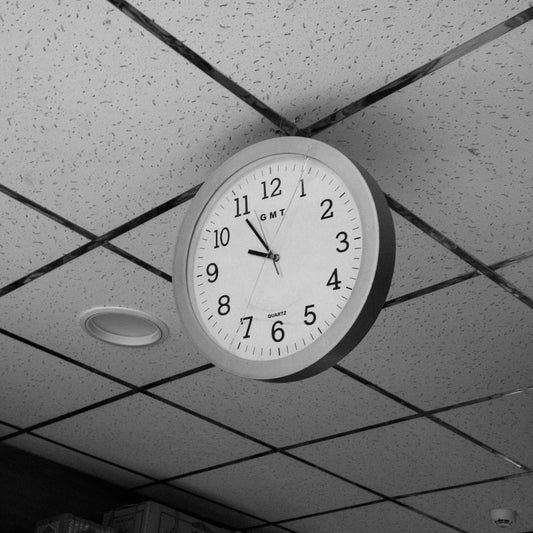 A clock hanging from the ceiling of a room