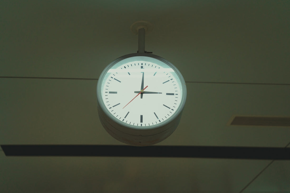 A clock hanging from the ceiling of a room