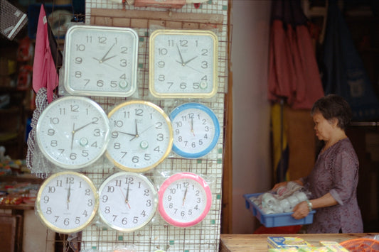 Clocks are displayed, and a woman holds items.