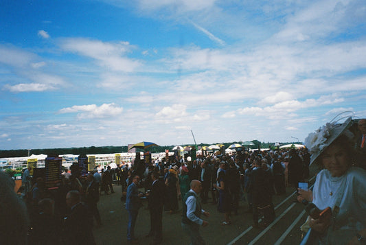 Large crowd gathered under a blue sky